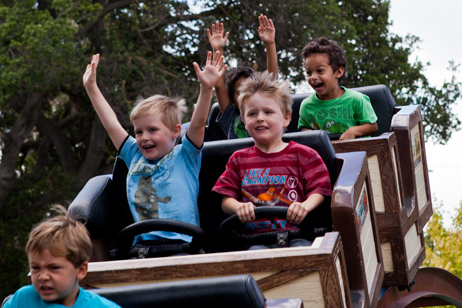 Andrew and Will riding the roller coaster at Happy Hollow 2