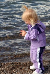 Ella throwing rocks into the lake