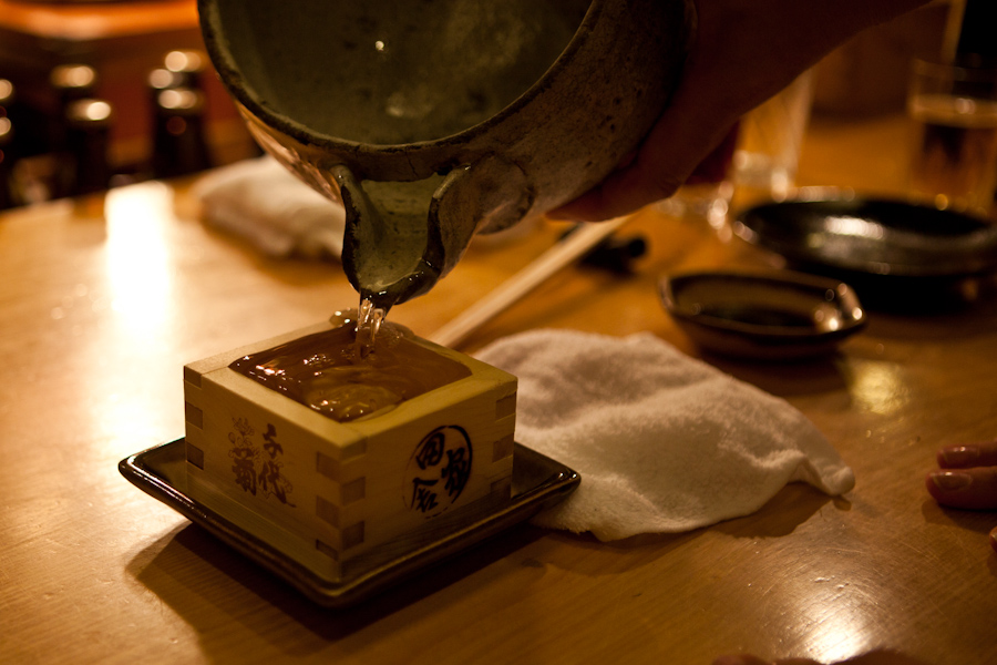 Overflowing sake pour