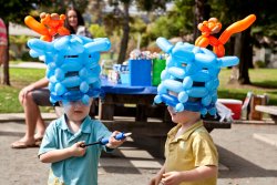 Andrew and Will in their birthday balloon hats