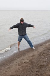 Dude on our tour dips his foot into the Arctic Ocean