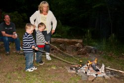 Andrew and Will roasting marshmallows with Kathy